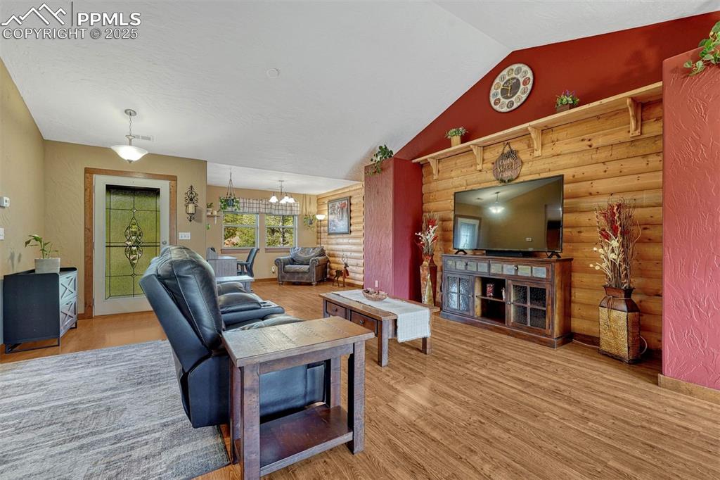 Image 12 of 30: Hardwood floors in the main living area have been beautifully maintained