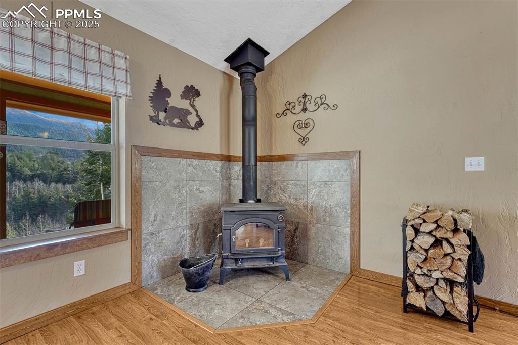 Image 13 of 30: A wood-burning stove is a great source for providing heat and sets a cozy v