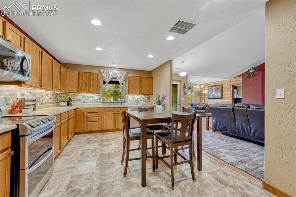 Image 14 of 30: The eat-in kitchen is well lit, spacious and has plenty of counter space to