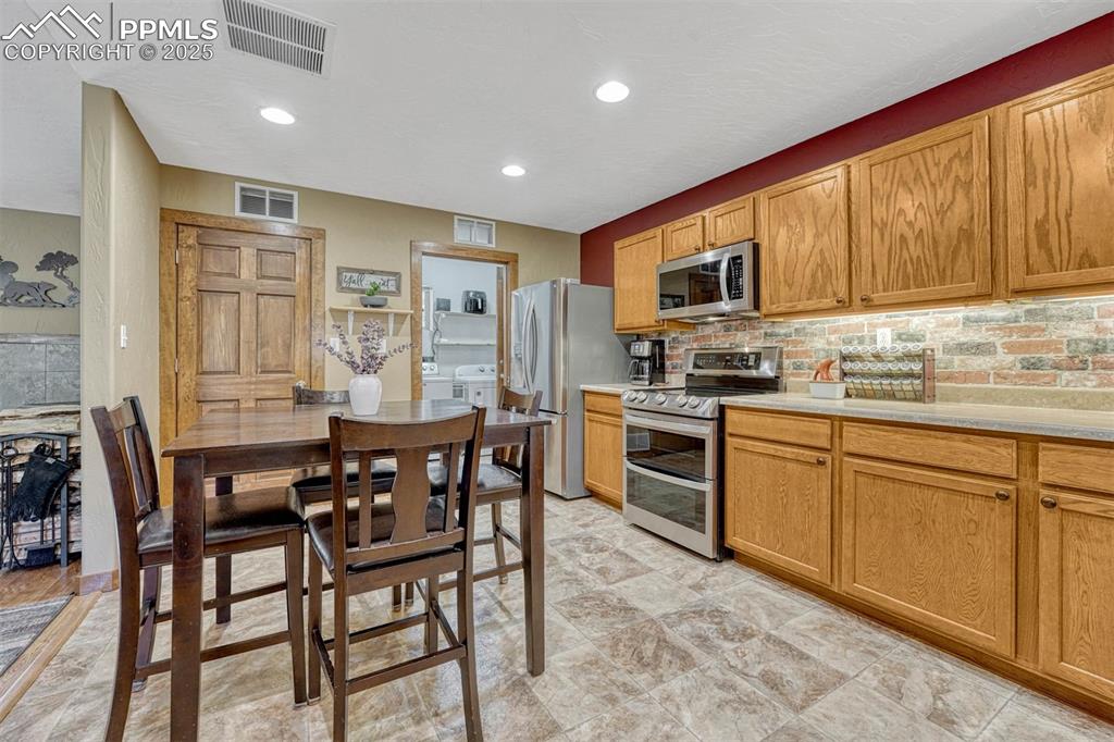 Image 15 of 30: Conveniently located off the kitchen are the pantry, laundry room and garag