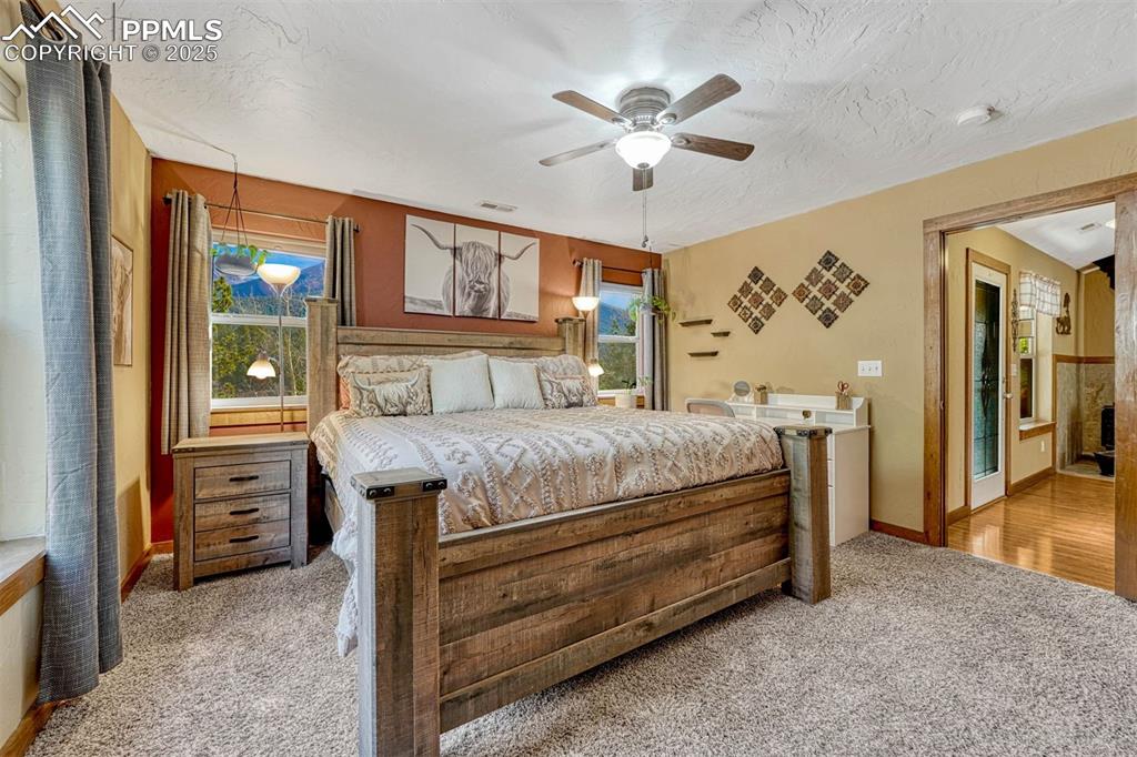 Image 22 of 30: The northeast facing bedroom has mountain and forest views