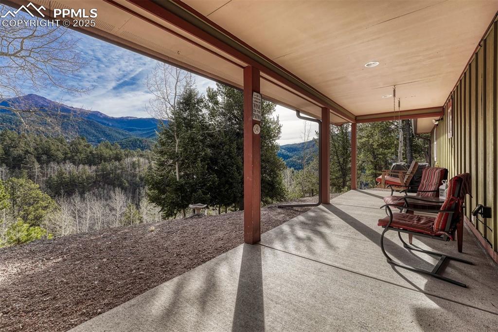 Image 3 of 30: East facing porch gives unobstructed views of Pikes Peak and the forest sur