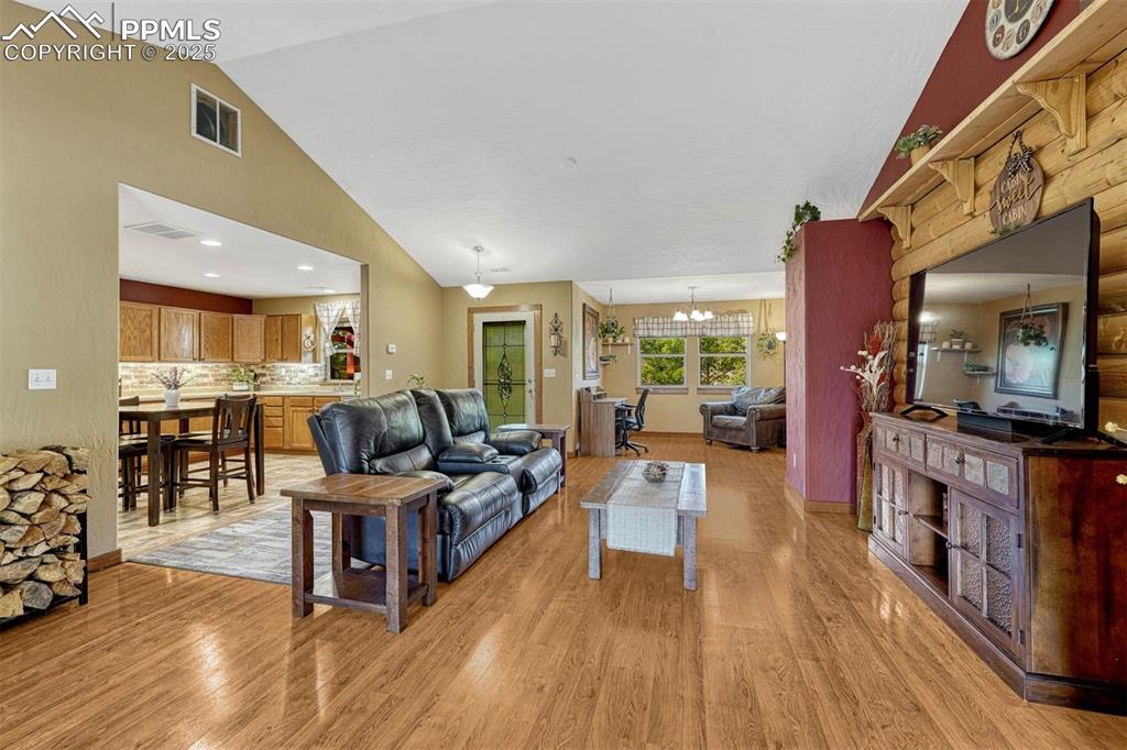 Image 4 of 30: Natural wood finishes, rustic exposed logs and warm tones are present throu