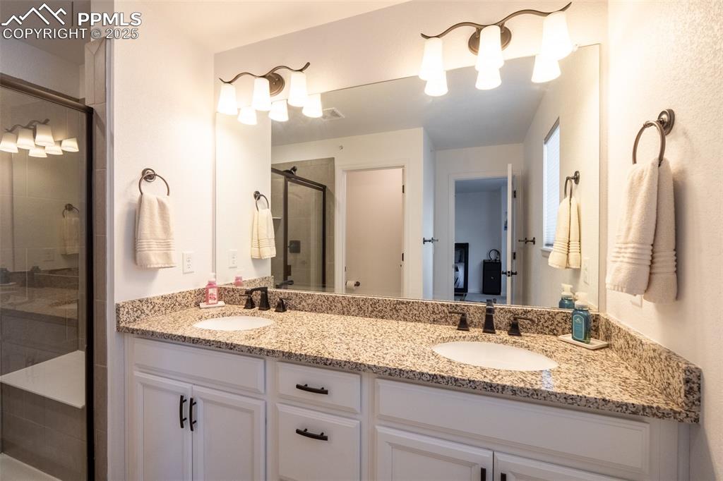 Image 24 of 40: Primary 3/4 bathroom (3) with dual sinks - upper floor