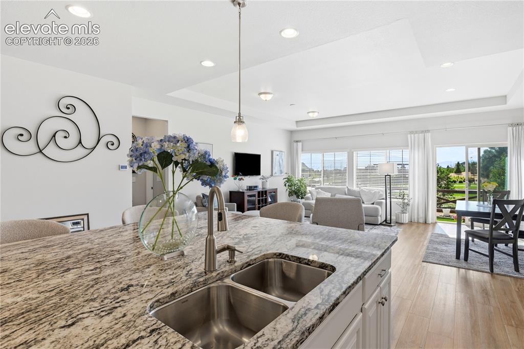 Image 12 of 47: Spacious open-concept living area featuring an expansive kitchen island wit