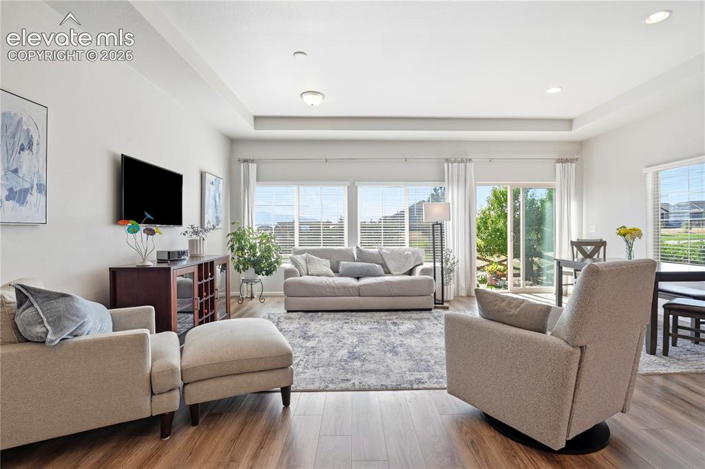 Image 17 of 47: Spacious living area featuring wood-finish flooring, recessed lighting, and