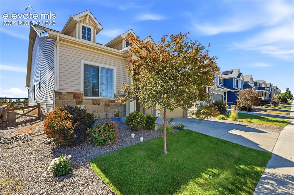 Image 2 of 47: Curb appeal featuring a stone and siding exterior with dormer windows