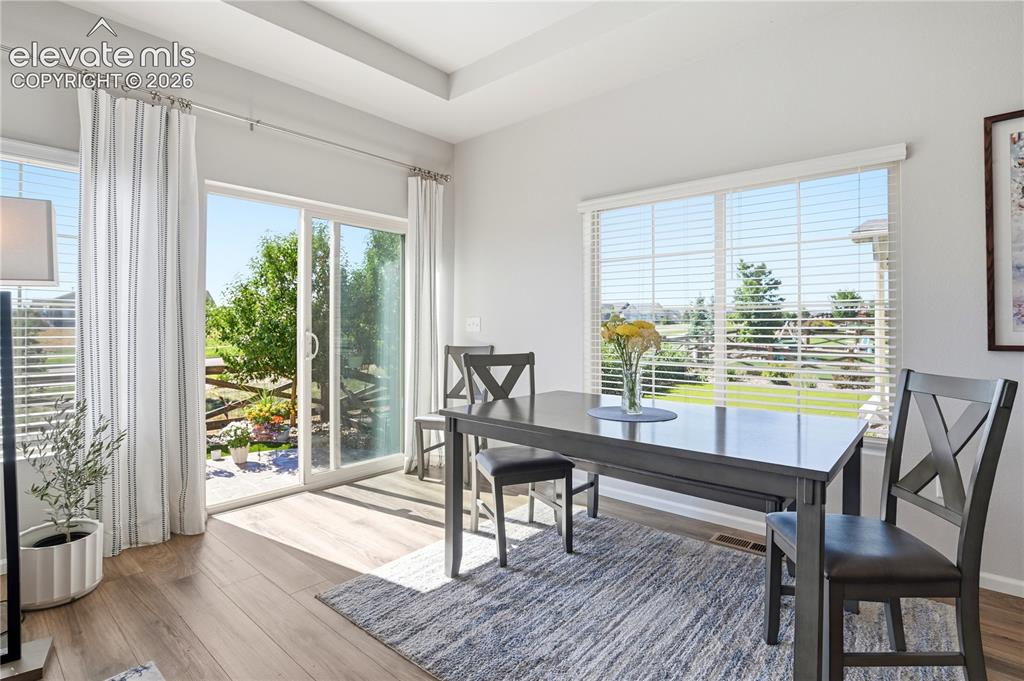 Image 23 of 47: Dining area featuring wood-finish flooring, a large sliding glass door, an 