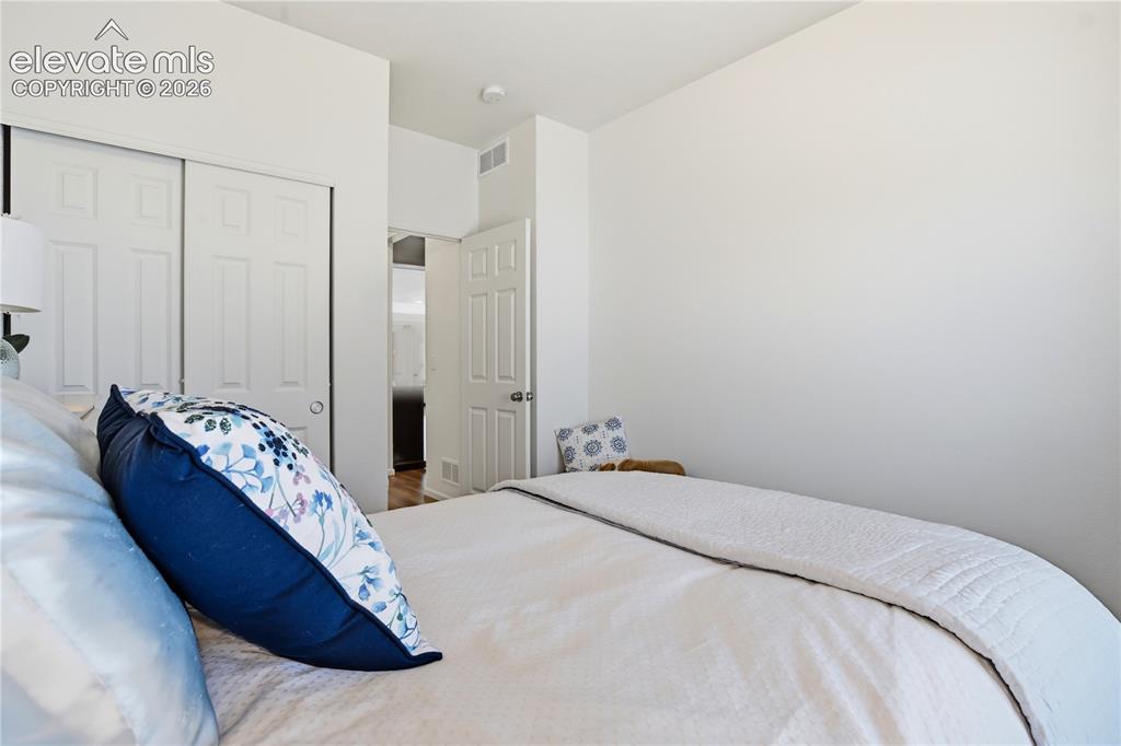 Image 25 of 47: Bedroom featuring white walls and a white six-panel bi-fold closet door