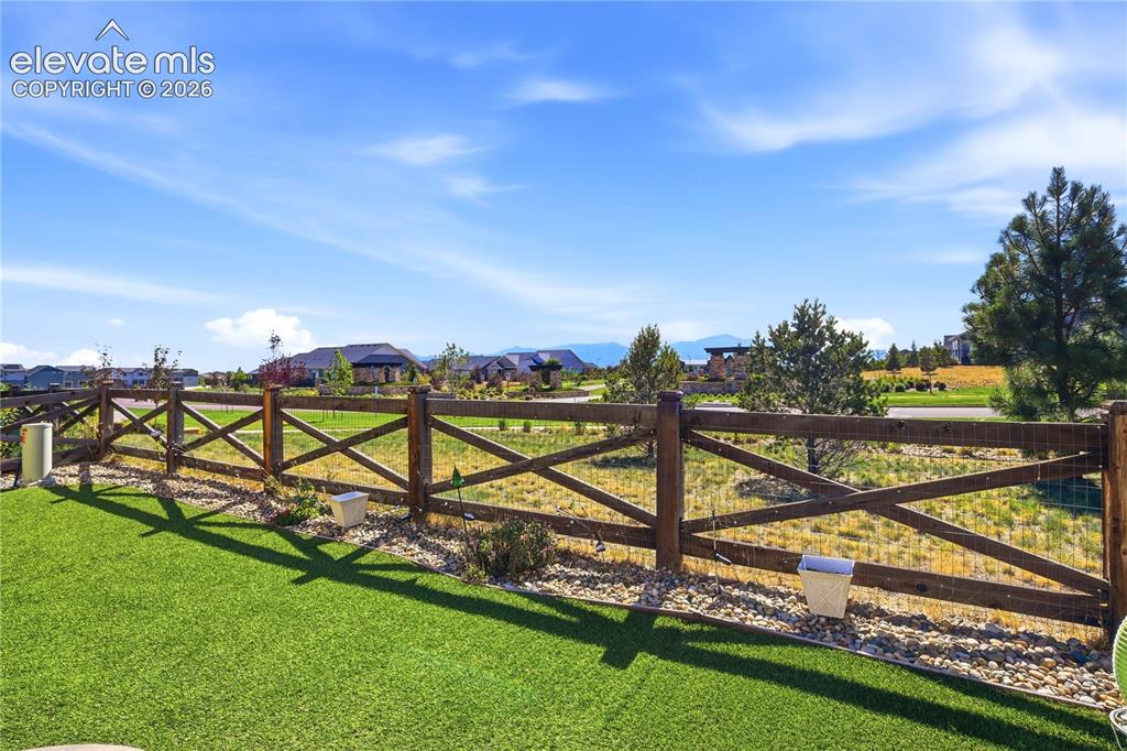 Image 35 of 47: Expansive outdoor space featuring artificial turf, a decorative wood crossb