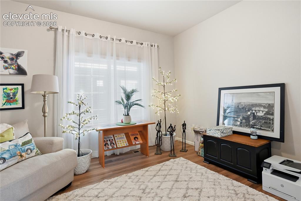 Image 4 of 47: Light-filled interior featuring neutral wall tones and wood-finish flooring