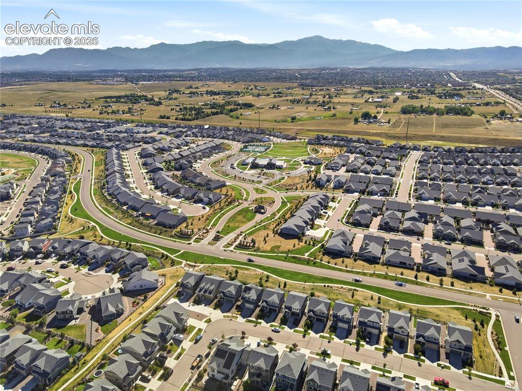 Image 46 of 47: Expansive residential community featuring curved streets, uniform architect