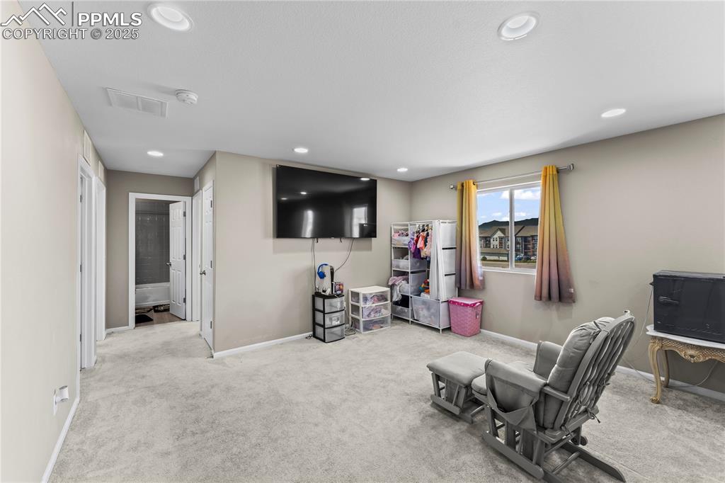 Image 15 of 32: Sitting room with carpet flooring and recessed lighting