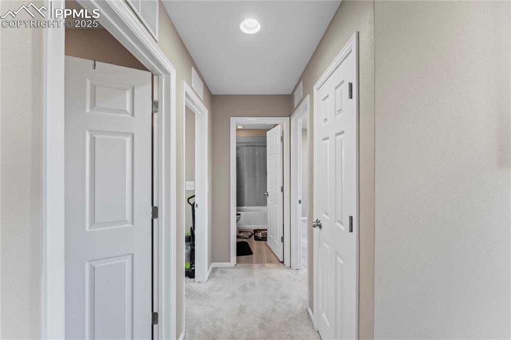 Image 20 of 32: Hall featuring light carpet and baseboards