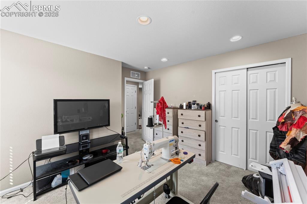 Image 22 of 32: Office area featuring light carpet and recessed lighting