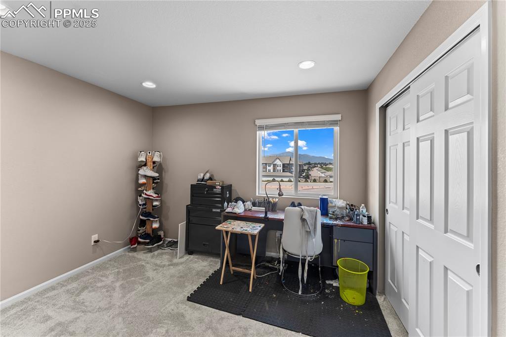 Image 23 of 32: Home office featuring light colored carpet and recessed lighting