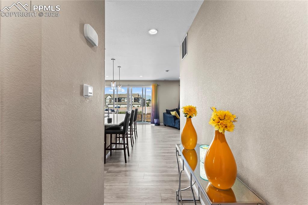 Image 5 of 32: Hallway featuring a textured wall, light wood-type flooring, and recessed l