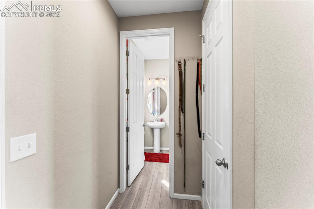 Image 6 of 32: Corridor with light wood finished floors and baseboards