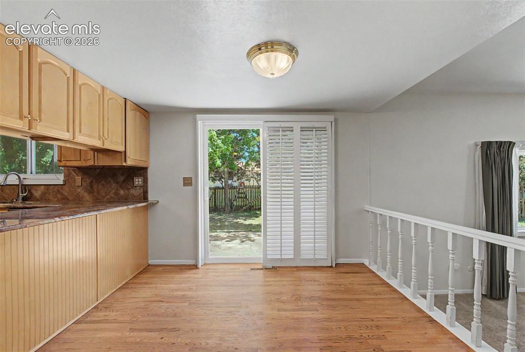 Image 15 of 49: In the Kitchen is an additional dining area, which has access to the backya
