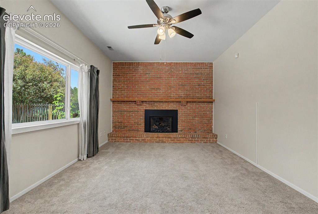 Image 18 of 49: The Family Room features a beautiful fireplace to cozy up by!