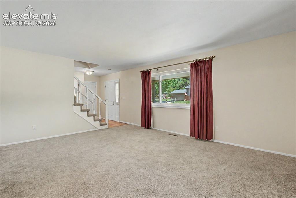Image 6 of 49: Upon entering the home, you are invited in by a spacious Living Room!