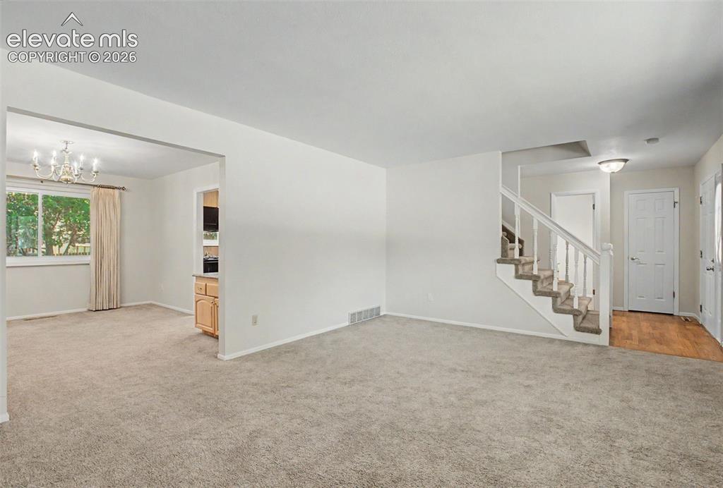 Image 8 of 49: The Living Room leads into the formal Dining Room
