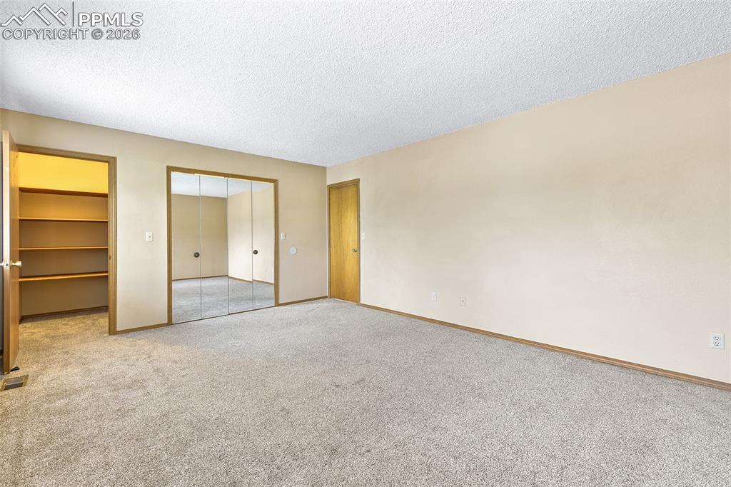 Image 12 of 22: Bedroom #1 With View Into Walk-In Closet