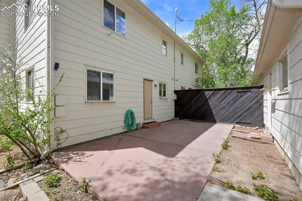 Image 17 of 22: Patio And Rear Door , With View Of 2 Car Garage