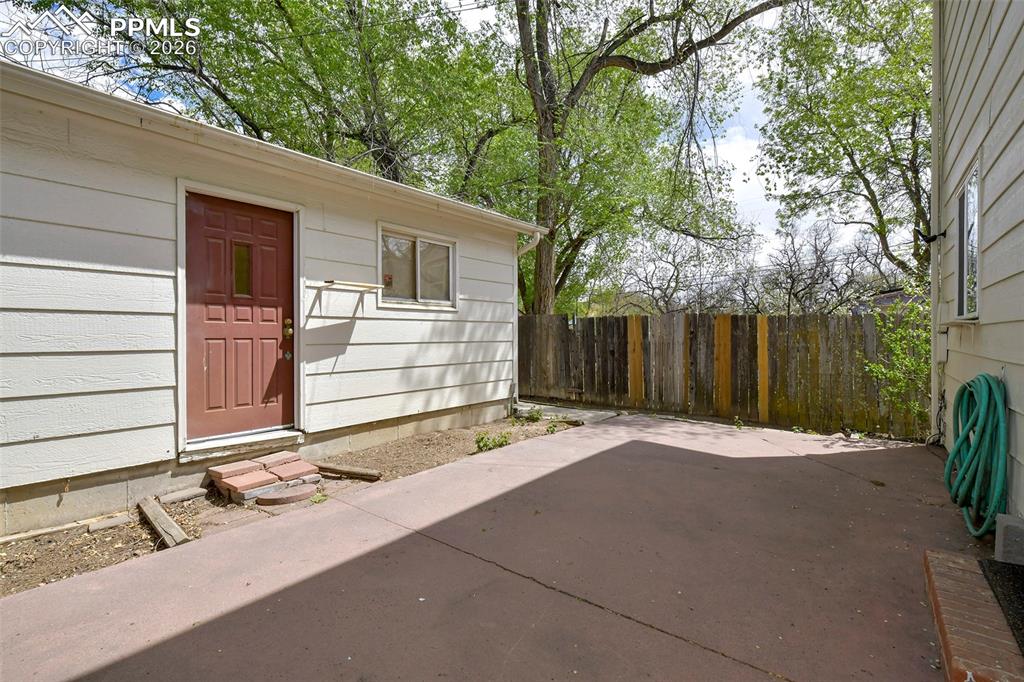 Image 19 of 22: Patio And View Of Garage/Garage Service Door