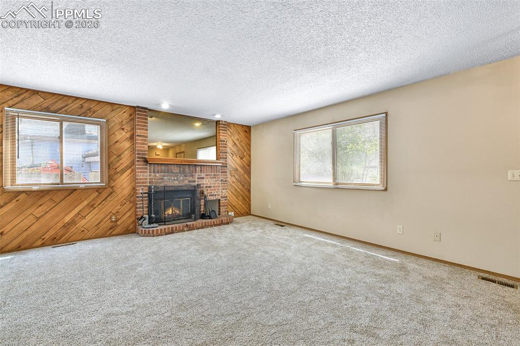 Image 2 of 22: Living Room With Wood Burning Fireplace