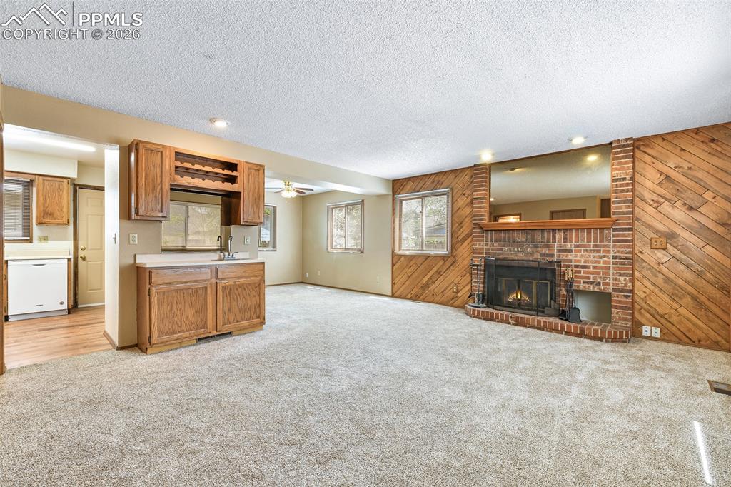 Image 3 of 22: Living Room With Wet Bar And Fireplace