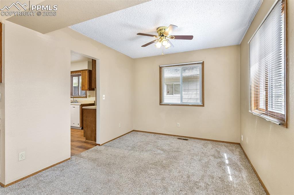 Image 6 of 22: Dining Room With View Into Kitchen