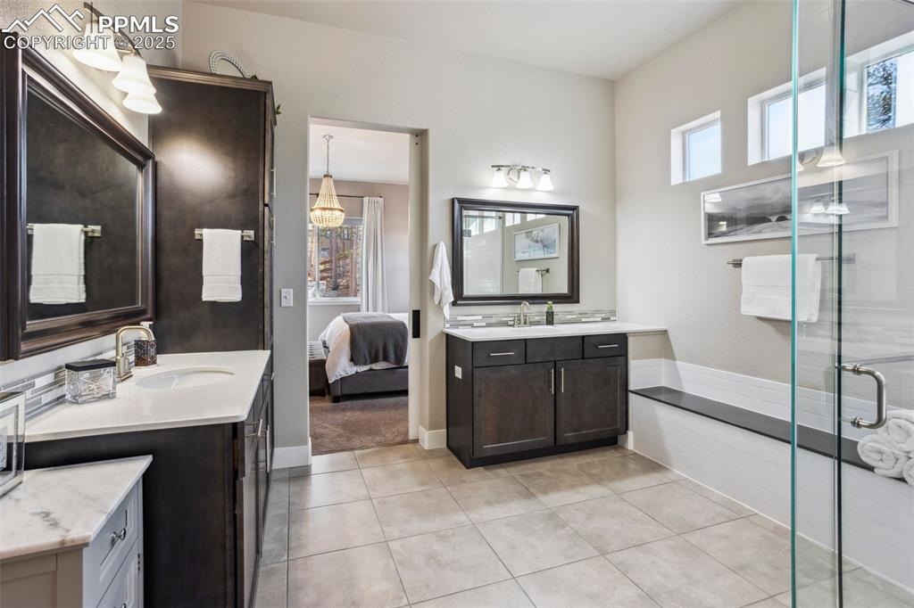 Image 17 of 48: Primary Bathroom, espresso soft close cabinetry, quartz counters and bench,