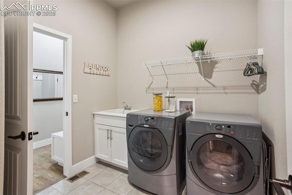 Image 32 of 48: laundry with sink (conveniently accessed via Master closet or hallway)