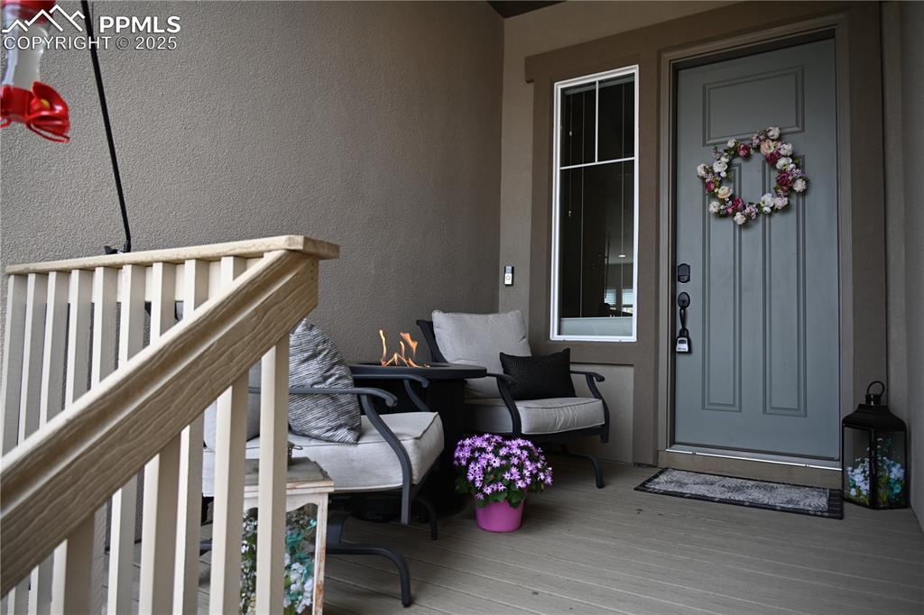 Image 41 of 48: Relaxing front deck enjoys the sounds of the bubbling boulder while viewing