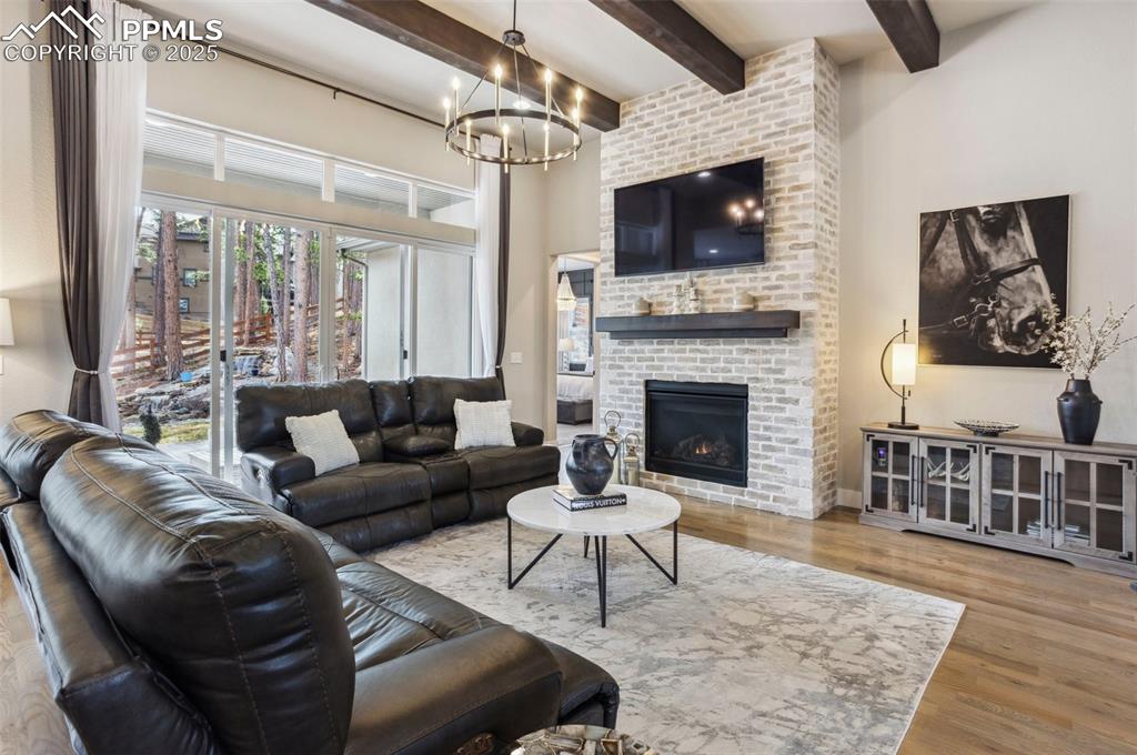 Image 8 of 48: floor to ceiling tumbled brick, gas fireplace & dual sliding glass doors br