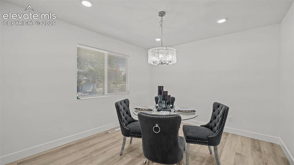 Image 10 of 44: Recessed ceiling lighting, a contemporary chandelier, a window with horizon