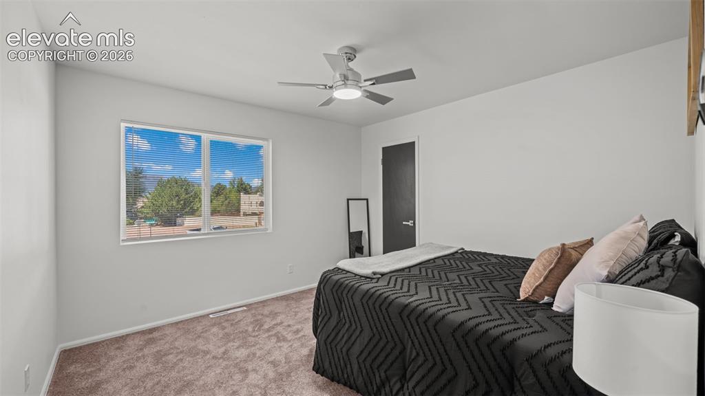 Image 20 of 44: Carpeted flooring, contemporary ceiling fan with integrated lighting, and a