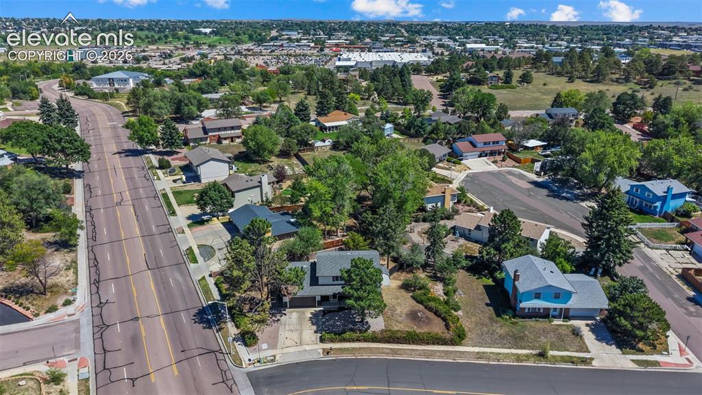 Image 41 of 44: Residential neighborhood with mature trees, visible homes, and paved roads