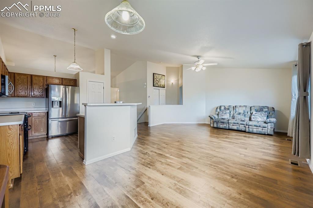 Image 11 of 29: Kitchen featuring appliances with stainless steel finishes, decorative ligh