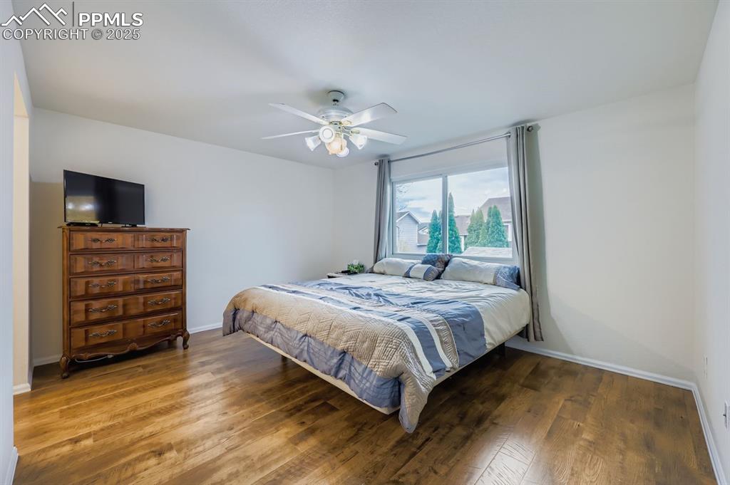 Image 14 of 29: Bedroom featuring hardwood / wood-style flooring and a ceiling fan