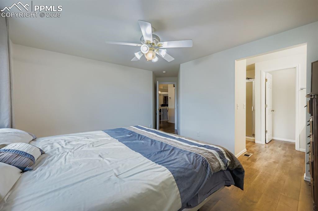 Image 15 of 29: Bedroom featuring wood finished floors and a ceiling fan