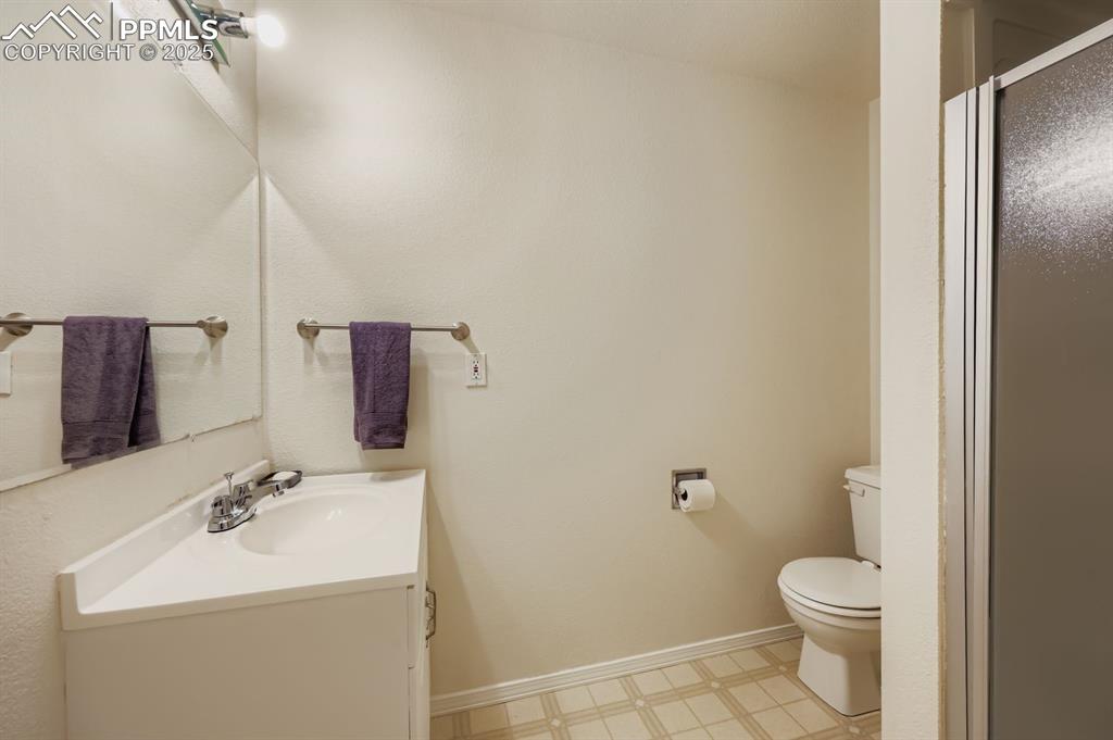 Image 26 of 29: Full bath featuring vanity and a shower with shower door