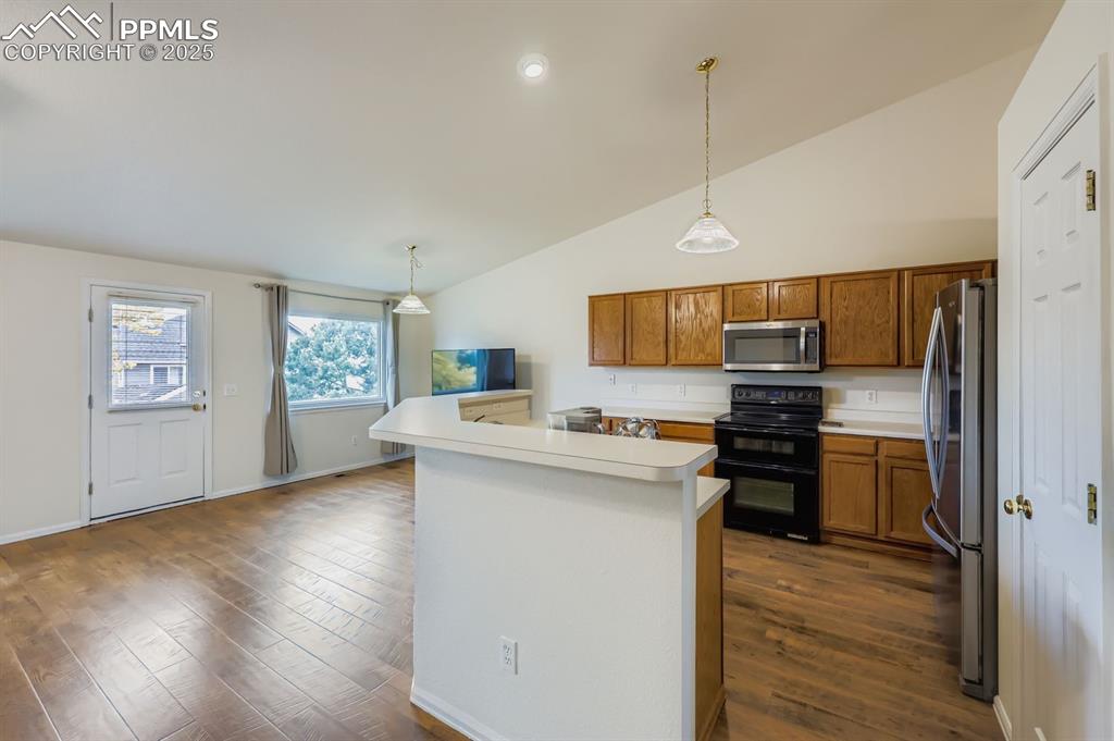 Image 8 of 29: Kitchen with oak cabinets, appliances with stainless steel finishes, decora