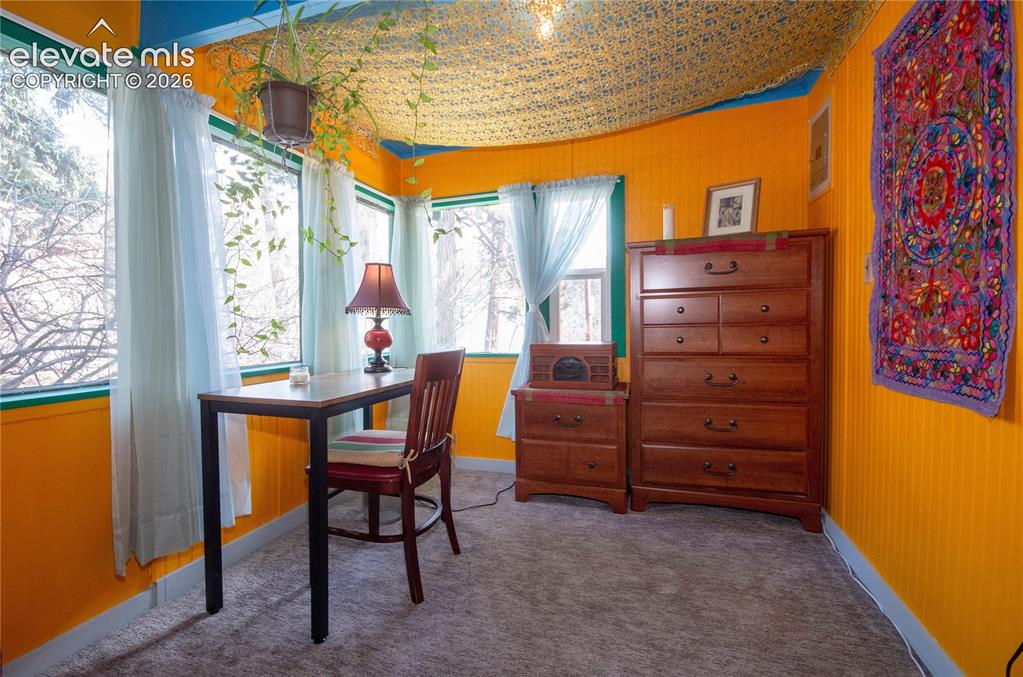 Image 13 of 27: Sitting room off primary bedroom