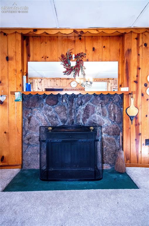 Image 22 of 27: Stone woodburning fireplace