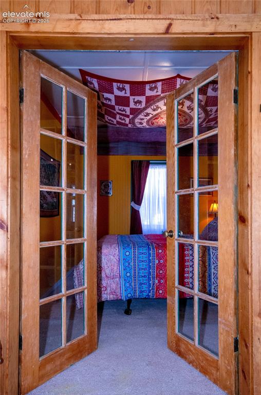Image 23 of 27: French doors to bedroom