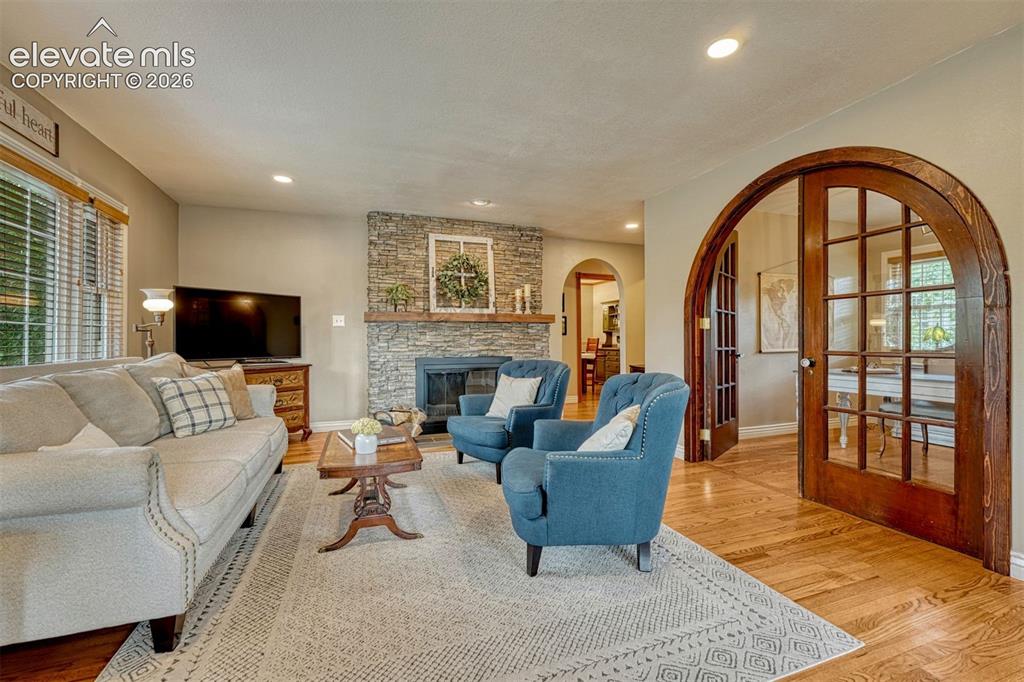 Image 4 of 50: Inviting great room with a wood-burning stone fireplace.