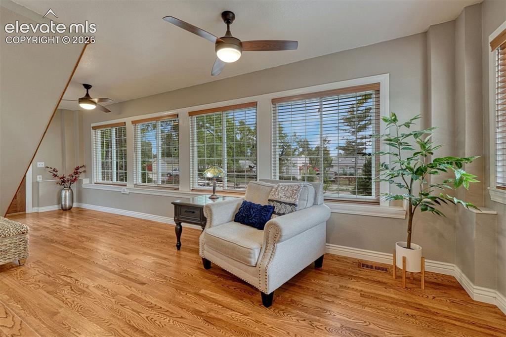 Image 7 of 50: Additional living space with gorgeous hardwood floors and a wall of windows