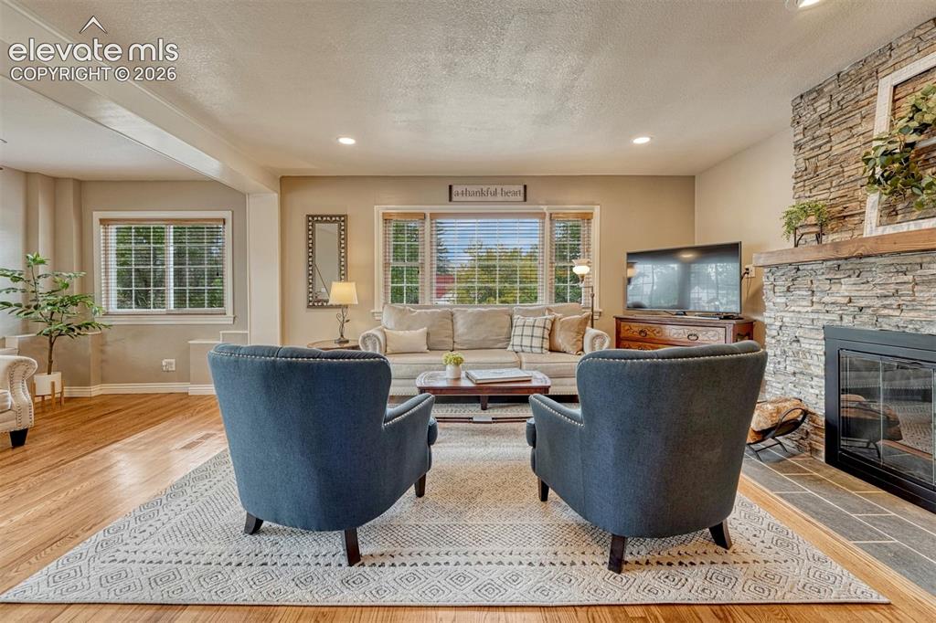 Image 8 of 50: Cozy living room with wood-burning fireplace.